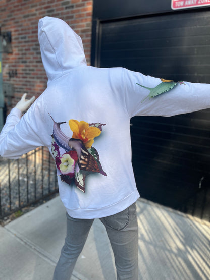 Mannequin wearing white hoodie of Snail with orchids and begonias, climbing its way up the back side.